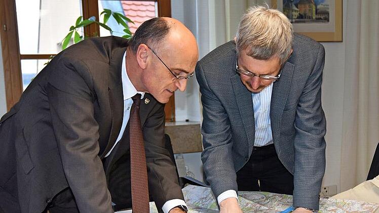 Gerhard Hartmann, Leiter des Amtes für Digitalisierung, Breitband und Vermessung (ADBV), überreichte die neuen Umgebungskarten des Landkreises Haßberge an Landrat Wilhelm Schneider (links).  Foto: Moni Göhr/Landratsamt Haßberge