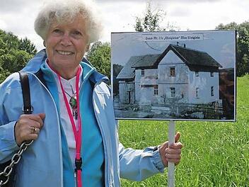 Rosa Weiglein mit dem Bild ihres Elternhauses auf der Wiese, wo es bis zur Absiedelung im Jahre 1938 gestanden hat.  Foto: Stephanie Elm