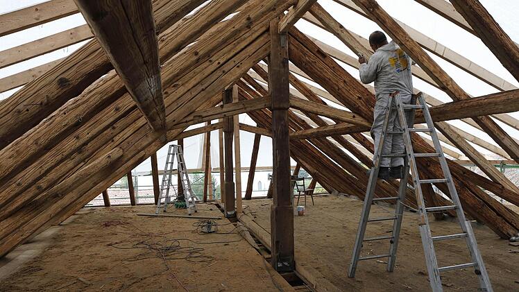 In mühsamer Handarbeit reinigten Arbeiter die Sparren auf dem Spitzboden vom Ruß. Foto: Matthias Hoch