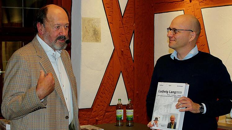 Fritz Lang (links) überreicht Oberbürgermeister Dirk Vogel ein Exemplar des Buches. Foto: Werner Vogel