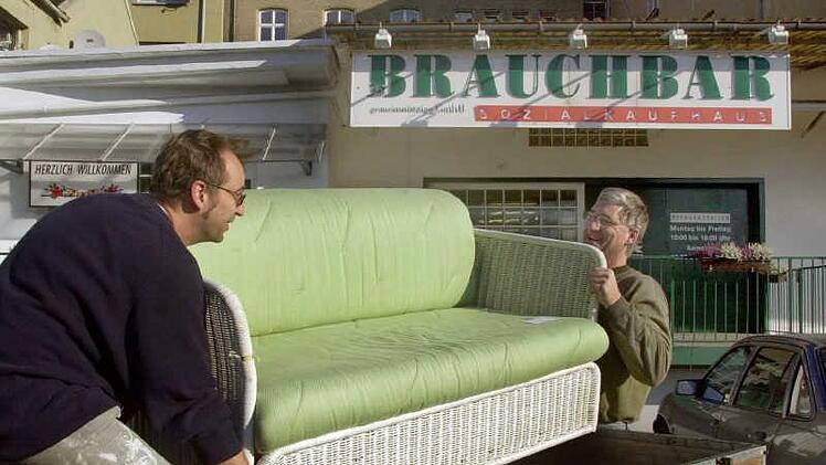 Zwei "Schnäppchenjäger" laden vor dem Würzburger Sozialkaufhaus "Brauchbar", ein von ihnen erstandenes Sofa auf einen Anhänger zum Abtransport. Symbolfoto: Karl-Josef Hildenbrand dpa/lby