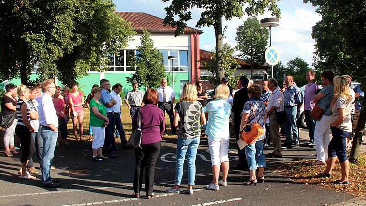 Vor der Adelsdorfer Schule versuchten Bürgermeister Fischkal und einige Gemeinderäte, die Bedenken der Eltern zu zerstreuen. Fotos: Johanna Blum