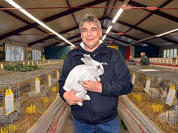 Bertram Trost, Zuchtwart beim Nüdlinger Kleintierzuchtverein, mit einem seiner Rassekaninchen "Kleinsilber hell", das ihm den Landesverbandsehrenpreis bescherte. Foto: Peter Rauch