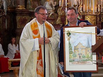Pfarrgemeinderatsvorsitzer Johannes Schuberth überreicht Pfarrer Seel zum Abschied ein Gemälde von der Buttenheimer Pfarrkirche. Alle Fotos: Andrea Spörlein