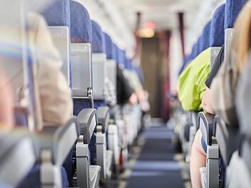 Unrecognizable people in the cabin of a commercial aircraft with rows of seats along the aisle. Daylight in the cabin of the airline. With space to copy. High quality photo Verstellbare Sitzlehnen, Sitzlehne Flugzeug, Kostenpflichtige Sitzlehnen, Flugzeug Komfort, Premium-Sitze Flugzeug, Economy-Class Komfort, Neue Sitzkategorien Flugzeug, Extended Comfort Section, Standard-Economy Sitze, Beinfreiheit Flugzeug, Kabinenaufteilung Airlines, Fluggesellschaft Komfortmodell, Zus&auml;tzliche Sitzreihen Flugzeug, Ergonomische Sitzpolsterung, Aufpreis f&uuml;r Sitzkomfort.