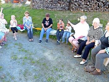 Im Kreis sitzend hörten die Mädchen und Jungen den Erzählungen von Marianne Nowack zu. Emmy Mähringer streute dazu noch das eine oder andere Singspiel ein.  Foto: Klaus-Peter Wulf