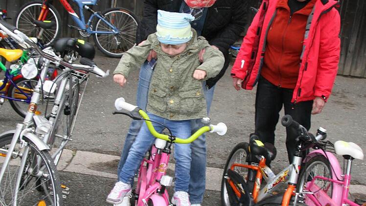 Lea-Angelina Schübelberger (mit Mama Kerstin Witzgall) probiert ein Fahrrad auf der SPD-Fahrradbörse aus und lässt sich von Anni Reuther beraten.