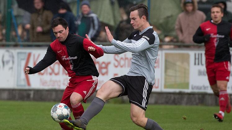 Der Steinberger Spielertrainer Pascal Zei&szlig; (graues Trikot) kann vor dem Wei&szlig;enbrunner Mittelfeldspieler Christopher Schneider kl&auml;ren.  Foto: Heinrich Wei&szlig;