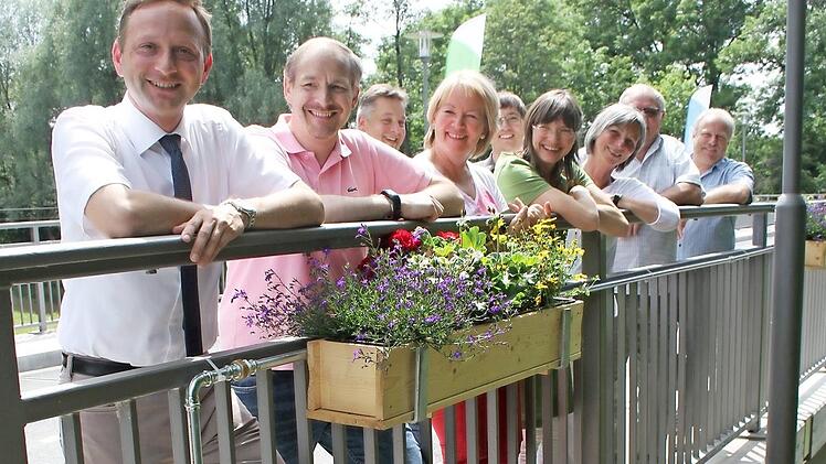 Bunt ist die Devise: rote Geranien, violett-blaue Lobelien und leuchtend gelbe Husarenknöpfchen sorgen auf der Brücke für Hingucker. Der Clou: die Blumen werden automatisch bewässert. Foto: Sonny Adam