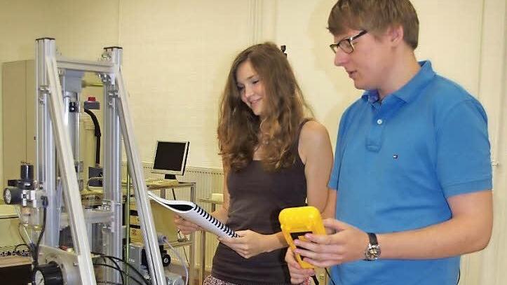 Franziska Stöcklein und Maximilian Krapp bei der Inbetriebnahme eines mechatronischen Systems.