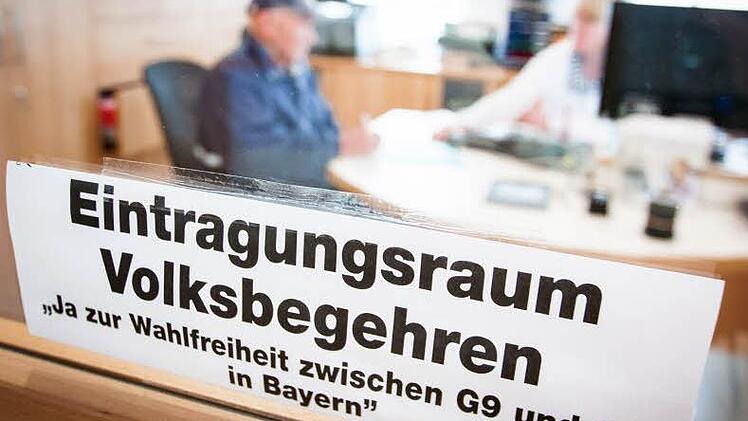 Hugo Baum (links) gibt im Regionalen Informations- und Tourismuszentrum (Ritz) in Eltmann seine Unterschrift für das Volksbegehren der Freien Wähler ab. Deutliche Beschilderung weist den Eltmanner Bürgern den Weg zum Eintragungsraum.  Fotos: Hendrik Steffens
