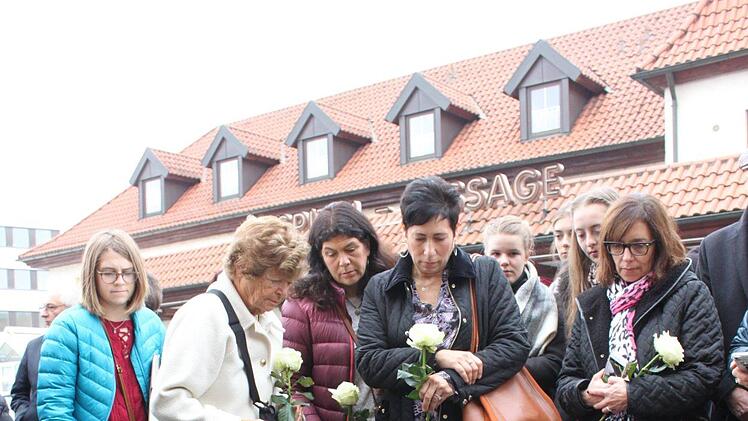 Angehörige legen an den Messing-Gedenkplatten nach jüdischem Brauch kleine Steine nieder.