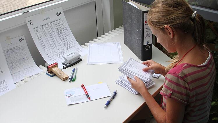 Anastasia Bergmann prüft im Bürgerbüro von Mini-Ku die Ausweise der Einwohner.
