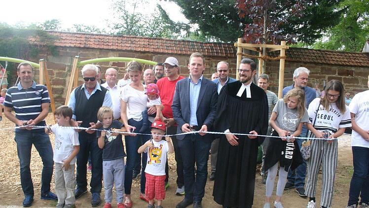 Unter großer Anteilnahme der Bevölkerung wurde der Spielplatz am Schlossplatz in Bad Rodach offiziell seiner Bestimmung übergeben. Bevor das obligatorische Band durchschnitten wurde, segnete Pfarrer Christian Rosenzweig die Einrichtung und alle, die sich dort aufhalten. Foto: Martin Rebhan