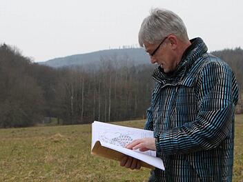 Noch kann Willi Scheller vom städtischen Büro Bauleistungen Bad Brückenau nur in Plänen blättern. Doch bald schon könnte hinter dem Baugebiet Oberes Straßfeld in Wernarz eine weitere Fläche für Häuslebauer erschlossen werden. Foto: Ulrike Müller