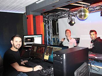 Schaltzentrale im Carrol's: Jannik Niermann (links) koordiniert den Stream der virtuellen Diskothek - DJ Eckes (Mitte) und DJ Marc Pain (rechts) legen Musik auf und moderieren. Sogar den coronabedingten Sicherheitsabstand haben die drei bedacht.  Foto: Sven Dörr