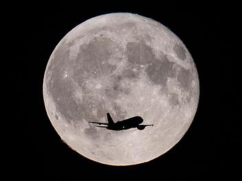 Flugzeug vor dem Vollmond