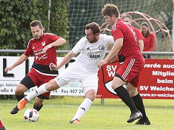 Der Sassendorfer Spielertrainer Dominik Stöhr (M.) wird von den beiden Weichendorfern  Peter Hecht (l.) und  Adrian Pfister angegriffen.sportpress