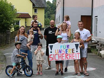 Die Anwohner der Straße "An der Steinach" (im Bild die drei Familien an der Engstelle mit ihren Kindern, rechts deren Sprecher Andreas Seidler) fordern, dass ihre Straße endgültig verkehrsberuhigt, am besten ganz gesperrt wird.