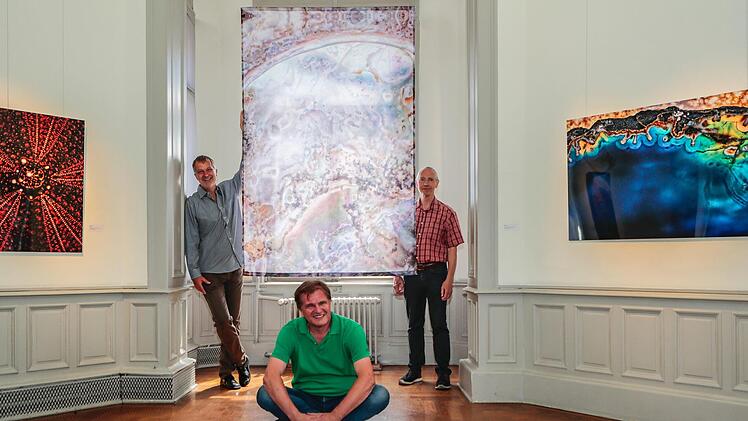 Thomas Wolf, Jürgen Schraudner und Bernd Seydel (v. l.) vor den Arbeiten der beiden "Makrosophen" Seeigel, Muschel und blaugelber Achat (v. l.) in der Ausstellung "Zeit gestalten"  Foto: Matthias Hoch