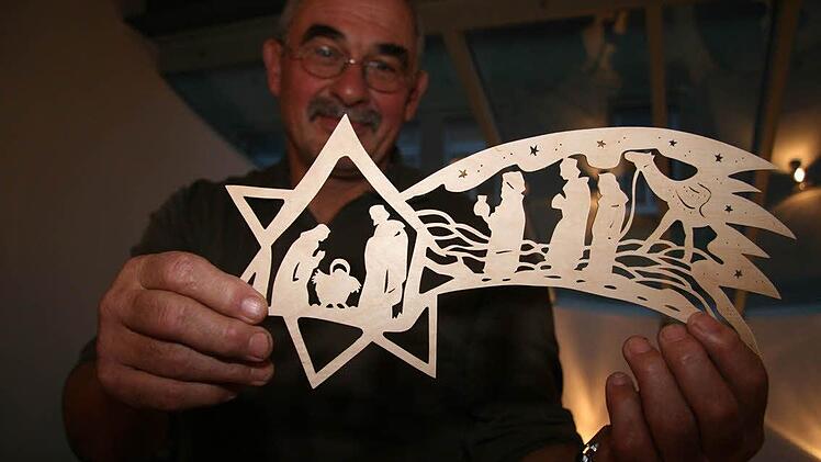 Peter Rösner sägt mit der Dekupiersäge aus nur einem Millimeter dicken Birkensperrholz filigrane Sterne.