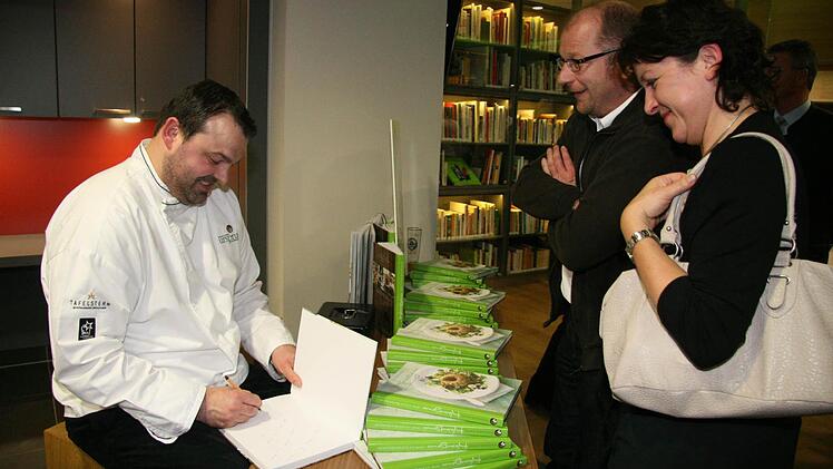 "Ich freue mich so, dass das Kochbuch jetzt fertig ist", sagt Alexander Schütz und signiert und schreibt gerne persönliche Widmungen.