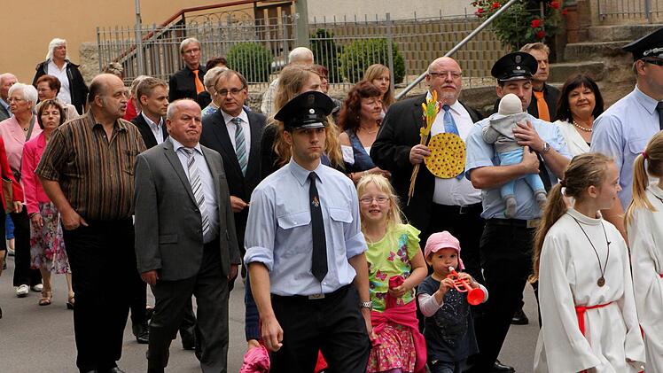 Die Bürgermeister, Kirchenräte und kirchlichen Mitarbeiter beim Festzug mit Pfarrer Martin Wissel zum "Oskar-Kandler-Zentrum".