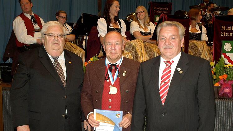 Stolz präsentiert Vorsitzender Stefan Hümmer die Medaille in Gold am weißblauen Bande. Links Bezirksvorsitzender Werner Pörner, rechts Kreisvorsitzender Wolfgang Müller. Foto: Susanne Deuerling