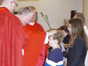 Ben Bauerfeind empfängt durch Domkapitular Josef Zerndl das Heilige Sakrament der Firmung. Mit auf dem Bild sind Kaplan Sven Raube (links) und Regionaldekan Thomas Teuchgräber (dritter von links).