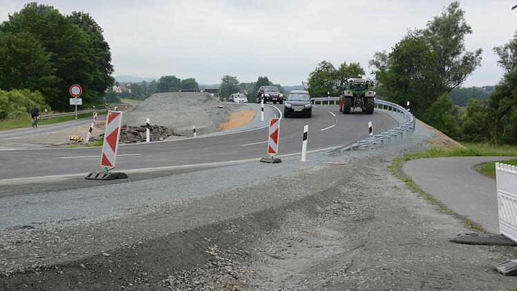 Jetzt fließt der Verkehr zügig über die neue Brücke zwischen Melkendorf und Katschenreuth. Die bisherige Engstelle bei der alten Sandsteinbrücke (links) gehört der Vergangenheit an. Foto: Dagmar Besand