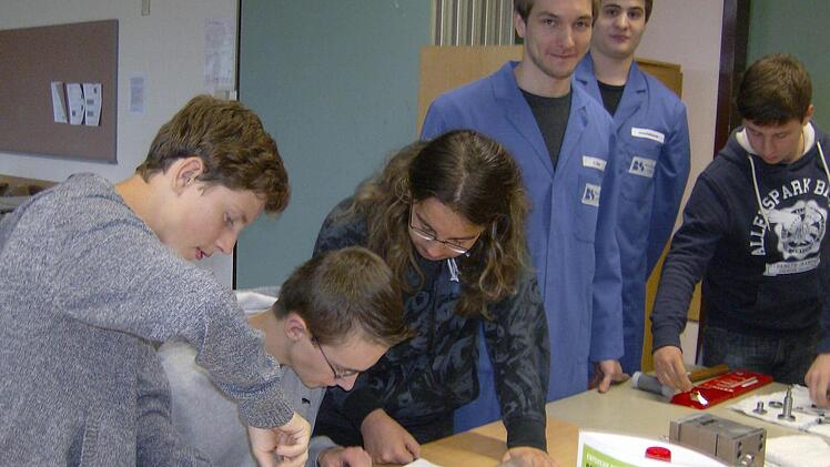 Die Schüler schauen sich an der Station 3 an, wie ein Kühlergrill entsteht.  Foto: Petra Malbrich