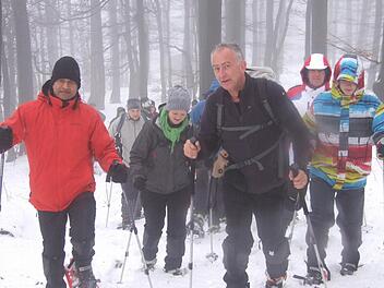 Durch den Buchenwald ging es mit Schneeschuhen hinauf zum Kreuzberg. Pater Augustin Parambakathu (links) und der Rhön-Yeti Andre Schmitt (zweiter von rechts) führten die Tour an. Fotos: Eckert