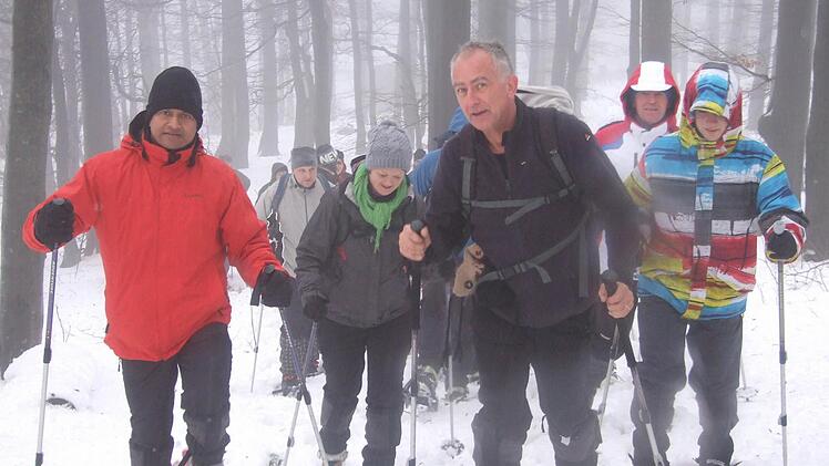Durch den Buchenwald ging es mit Schneeschuhen hinauf zum Kreuzberg. Pater Augustin Parambakathu (links) und der Rhön-Yeti Andre Schmitt (zweiter von rechts) führten die Tour an. Fotos: Eckert