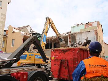 Ein Bagger knabbert Stück für Stück den Dachstuhl, die Betondecken und Wände des ehemaligen Kaufhauses ab.