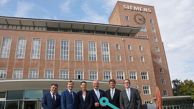 Der Schl&uuml;ssel wurde schon mal &uuml;bergeben, nutzen kann die FAU das Geb&auml;ude aber erst ab 2024. Im Bild: Zsolt Sluitner, CEO Siemens Real Estate, Klaus Helmrich, Mitglied des Vorstands der Siemens AG, Ministerin f&uuml;r Wissenschaft und Kunst, Marion Kiechle, Innenminister Joachim Herrmann, Joachim Hornegger, Pr&auml;sident der FAU, Florian Janik (v. l.)      Foto: Pascale Ferry