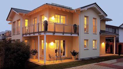 Der eckumlaufenden Balkon und der Walm-, Giebeldach Konstruktion machen dieses Fertighaus von Hanse Haus zu etwas ganz besonderem.   Foto: PR