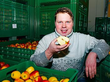 Ulrich  Gräb mit einem Pinova-Apfel. In die großen Lagerboxen in der Kühlhalle passen bis zu 350 Kilo Äpfel. Matthias Hoch