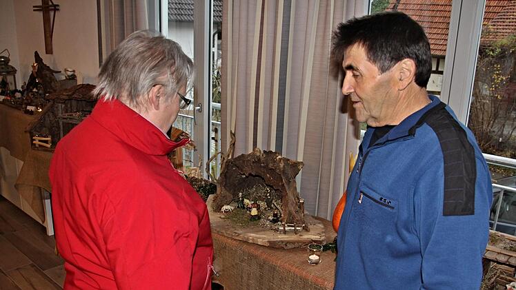 Martin Filbrich (rechts) gibt einer Besucherin Auskunft über sein Hobbyhandwerk Krippenbau. Foto: Helmut Will
