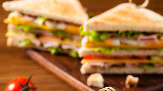 Delicious toast sandwich with ham, cheese, egg and vegetables.