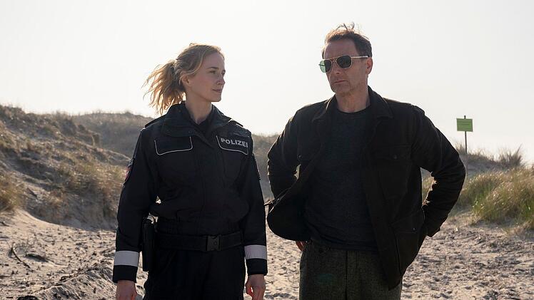 "Das Grab am Strand" war der erste Teil der Thriller-Reihe "Dünentod - Ein Nordsee-Krimi" bei RTL (Szene mit Pia-Micaela Barucki und Hendrik Duryn). Er basiert auf dem Roman "Dünengrab" von Sven Koch.
