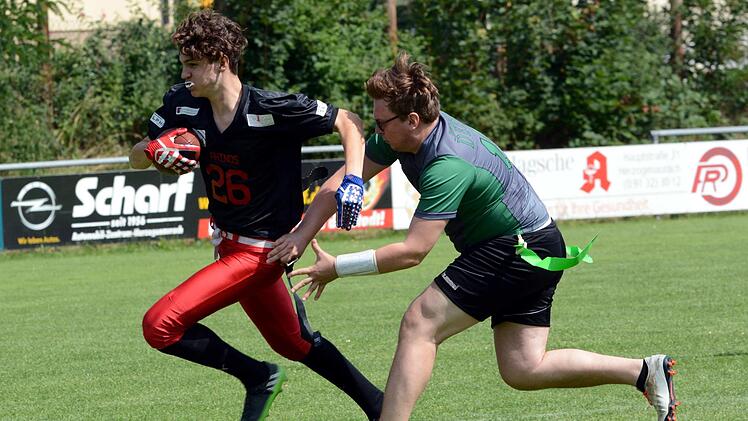 Hannes Staiger (li.) von den Herzo Rhinos wird von einem Spieler der Forstenried Deers attackiert, der versucht, dem Balltragenden eines der beiden Bänder aus der Hüfte zu ziehen.  Fotos: herzopress