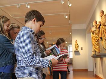 Ganz vertieft in ihre Aufgaben sind die Drittklässler (v. l.) Melina, Caroline, Fridolin, Vivienne und Greta. Sie müssen die Kunstwerke genau unter die Lupe nehmen, um die Lösungen zu finden. Foto: Marco Meißner