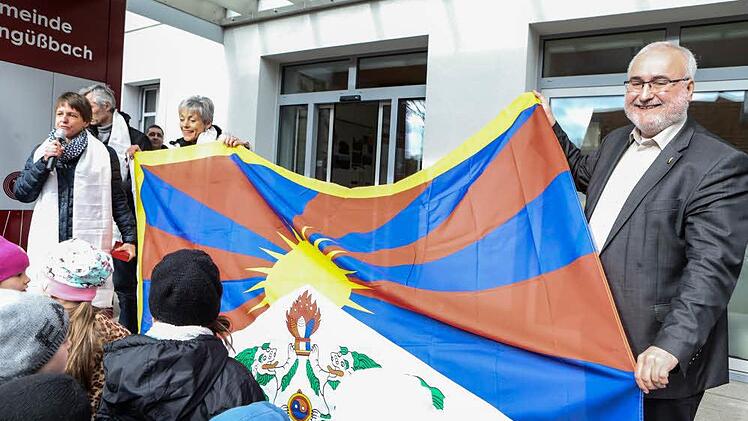 Breitengüßbachs Erste Bürgermeisterin Sigrid Reinfelder (UBB, mit Mikrofon), Schulleiterin Sibylle Kretzschmar und Wolfgang Grader, Vorsitzender der Tibet Initiative Deutschland e.V. halten mit den Schülern die Tibetflagge hoch. Foto: Barbara Herbst