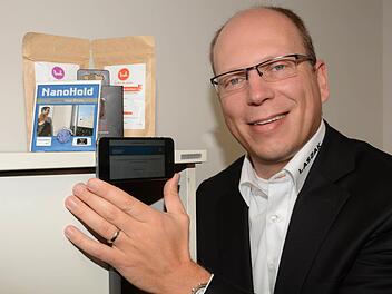 Pfiffiger Helfer: Der Nano-Hold ist ein Nanotechnologie-Kleber, mit dem Smartphones und Tablets an jeder beliebigen glatten Oberfläche befestigt werden können. Unternehmensgründer Tim Barkow hat die Klebefolie auch an der Rückseite seines eigenen Handys angebracht. Damit kann man nebenbei auch sehr komfortabel Selfies fotografieren und hat dabei die Hände frei. Foto: Dagmar Besand