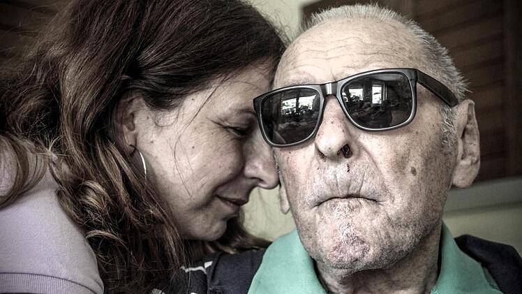 Alexandra lehnt ihren Kopf an den ihres Vaters Karl. Seine Demenz bereitet ihr oft Kummer. Aber sie ist sicher, dass Karl sich wohlfühlt.  Foto: Diana Fuchs