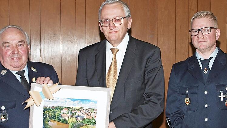 Günter Dippold (Mitte) überreichte dem Jubelverein ein Bild mit einer Ansicht von Schney, das der Vorsitzende Erich Wachsmann (li.) und Kommandant Alexander Ultsch (re.) in Empfang nahmen.