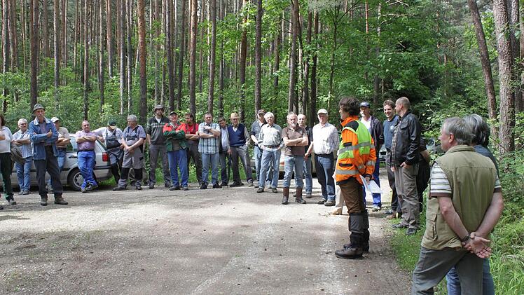 Dominic de Hasque erklärt den Teilnehmern anhand einer Bodenprobe die Baumarteneignung.
