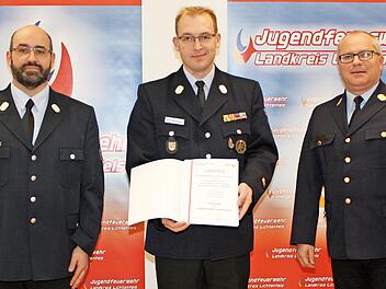 Kreisjugendfeuerwehrwart Kreisbrandmeister Tino Schamberger (links) und Kreisbrandrat Timm Vogler (rechts) &uuml;berreichten die Ehrennadel der Jugendfeuerwehr Oberfranken an Kreisbrandmeister Tobias Winterbauer (Neuensee, Mitte).