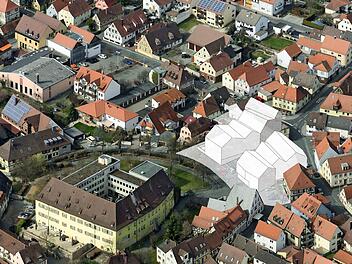 Das Modell f&uuml;r B&uuml;rgerzentrum und Bibliothek ist in ein Luftbild montiert worden.  Montage: Auer & Weber