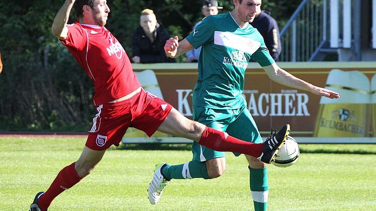 Langes Bein: Tobias Wölfel vom FSV Stadeln spitzelt dem Neudrossenfelder Sebastian Brand (rechts) den Ball weg. Foto: Herbert Georgius